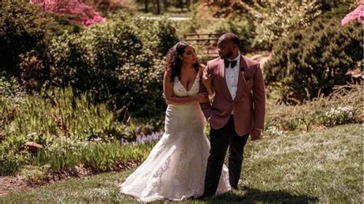 Couple Standing By The Mesmerizing Bliss River, Surrounded By Lush Greenery And Blooming Flowers Falling For The Ex (Bliss River 2)